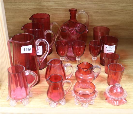 A collection of eighteen pieces of Victorian cranberry, glassware, together with a painted three shelf wall bracket tallest 16cm